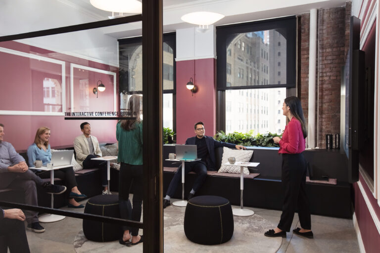 small group of people watching two women present