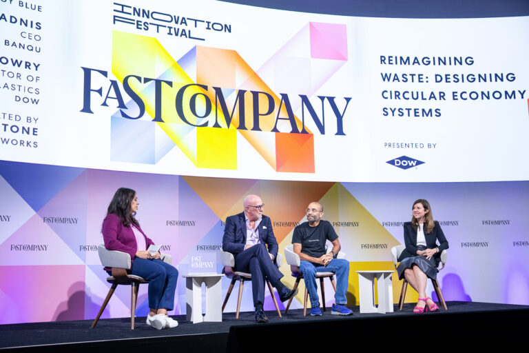 A panel of speakers on stage at Convene's 225 Liberty Street.