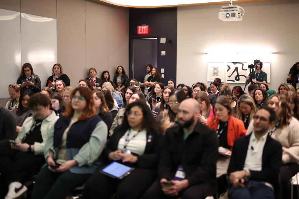 One of the Hub spaces at Convene Brookfield Place, 225 Liberty filled with people who are engaged and listening to a speaker. 
