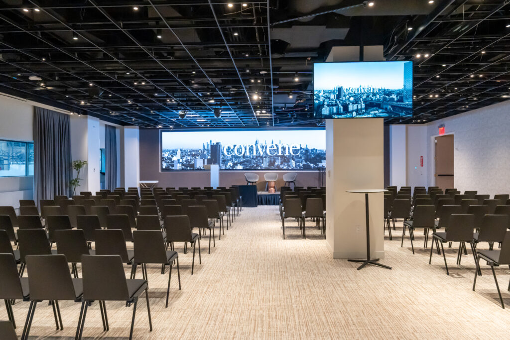 Large conference room with two digital screens