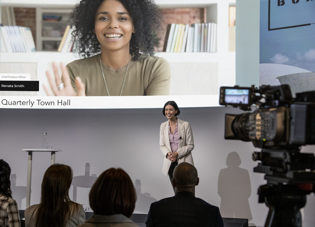 Video recording person presenting on stage