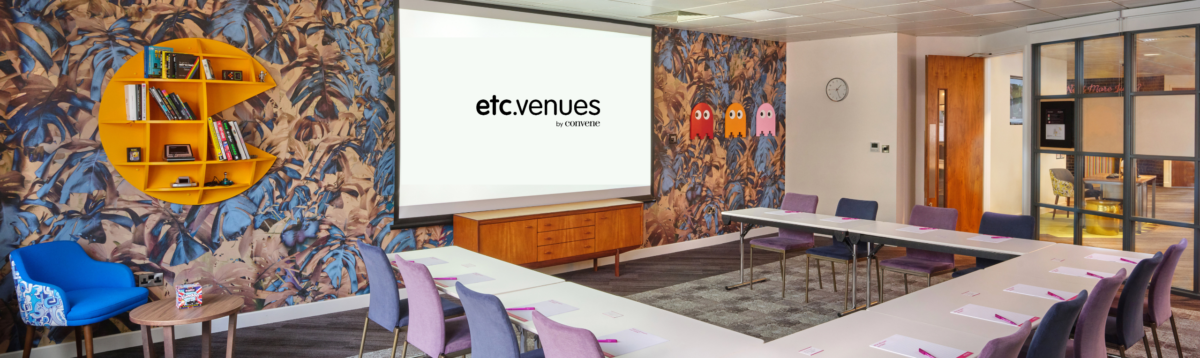 etc.venues Monument training center featuring a beautifully designed collaborative meeting room for small teams set in a U-configuration with large screen deployed for presentations