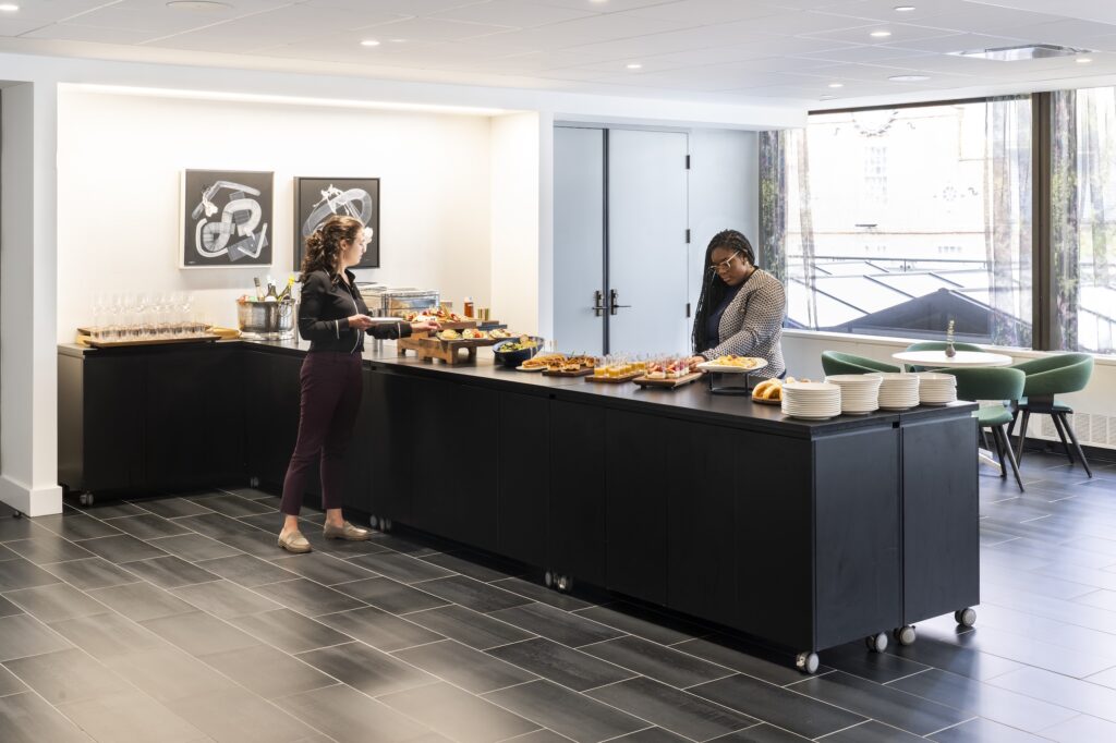 People getting food at a Convene buffet 