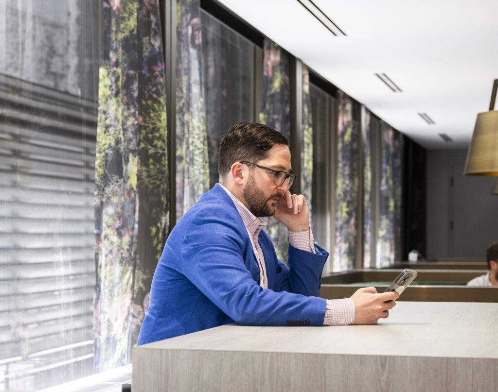 Man on phone at Convene One Boston Place