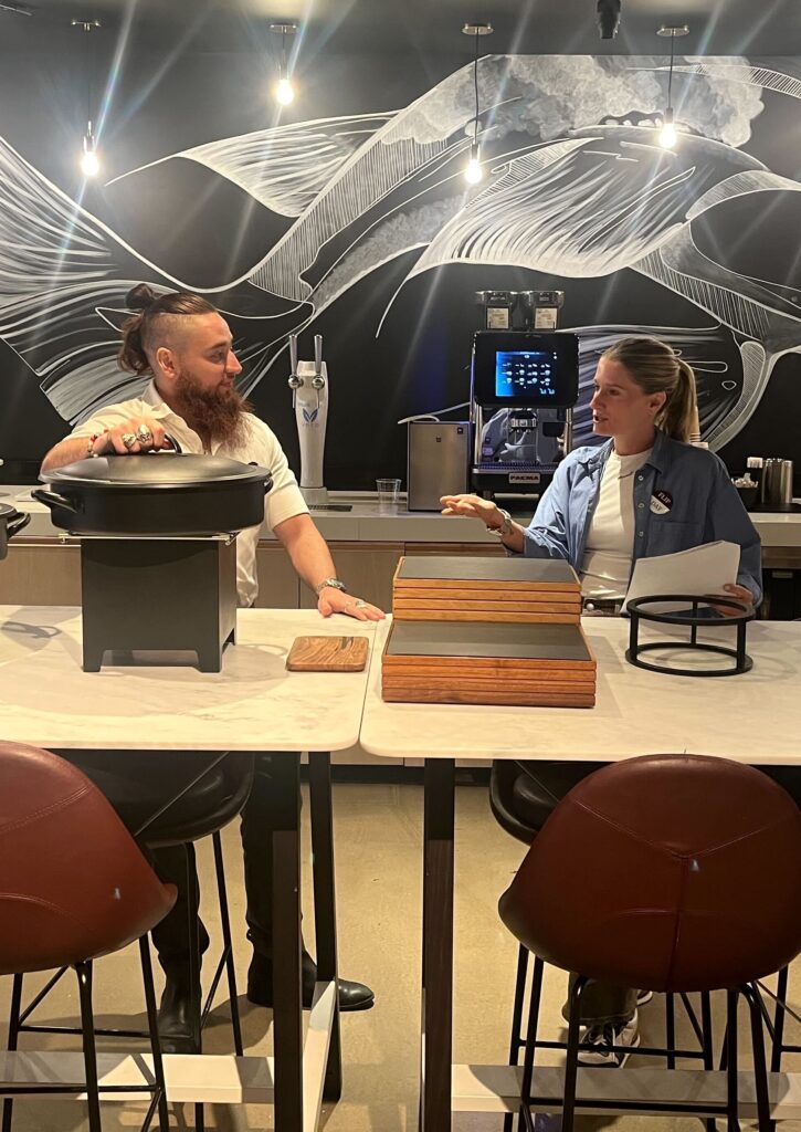 Two people discuss setting the buffet at Convene 237 Park
