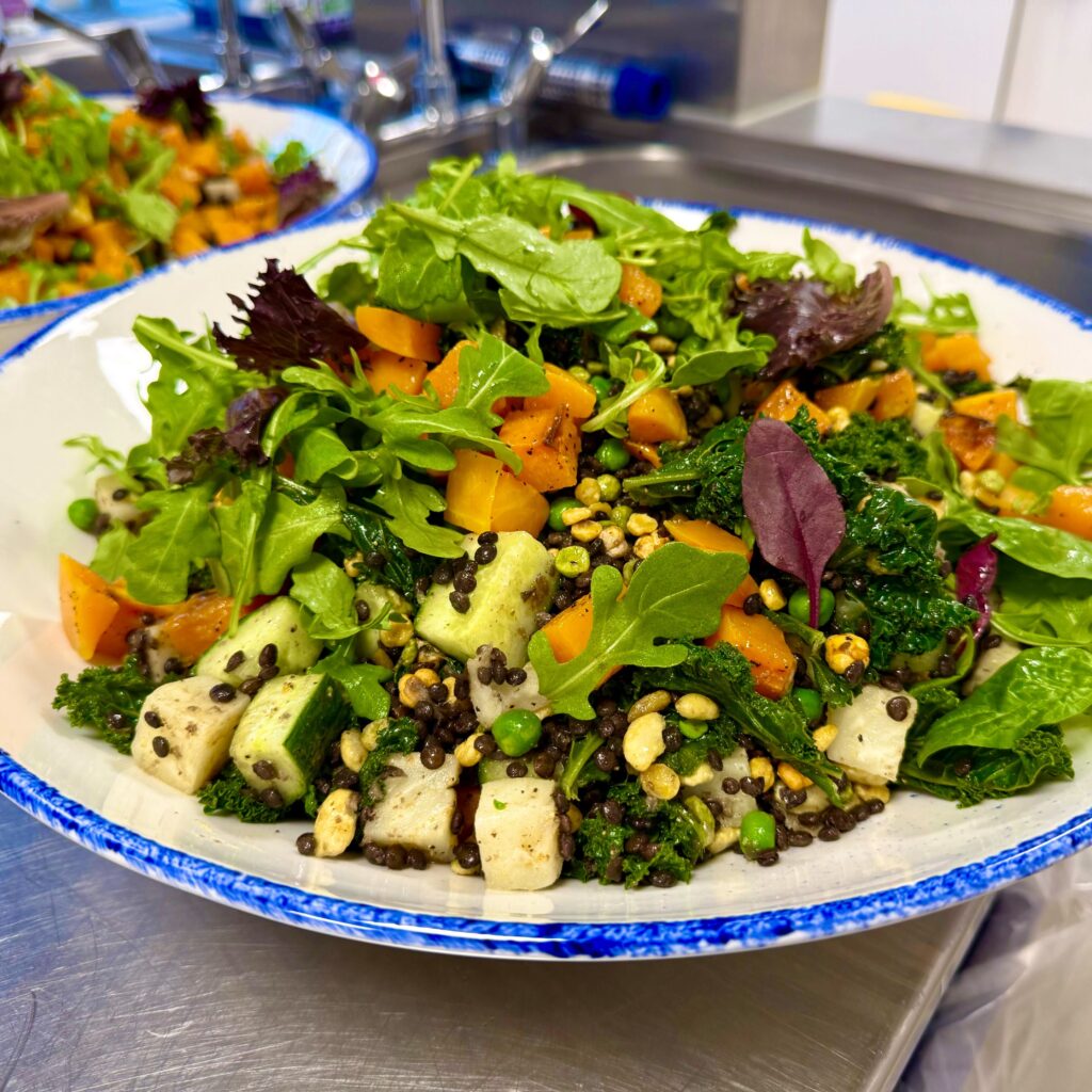roasted pumpkin salad with kale in blue and white platter