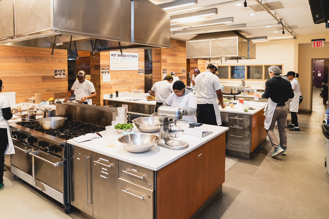 Convene and Hot Bread Kitchen partnership, image shows First Course training members in action in the kitchen.